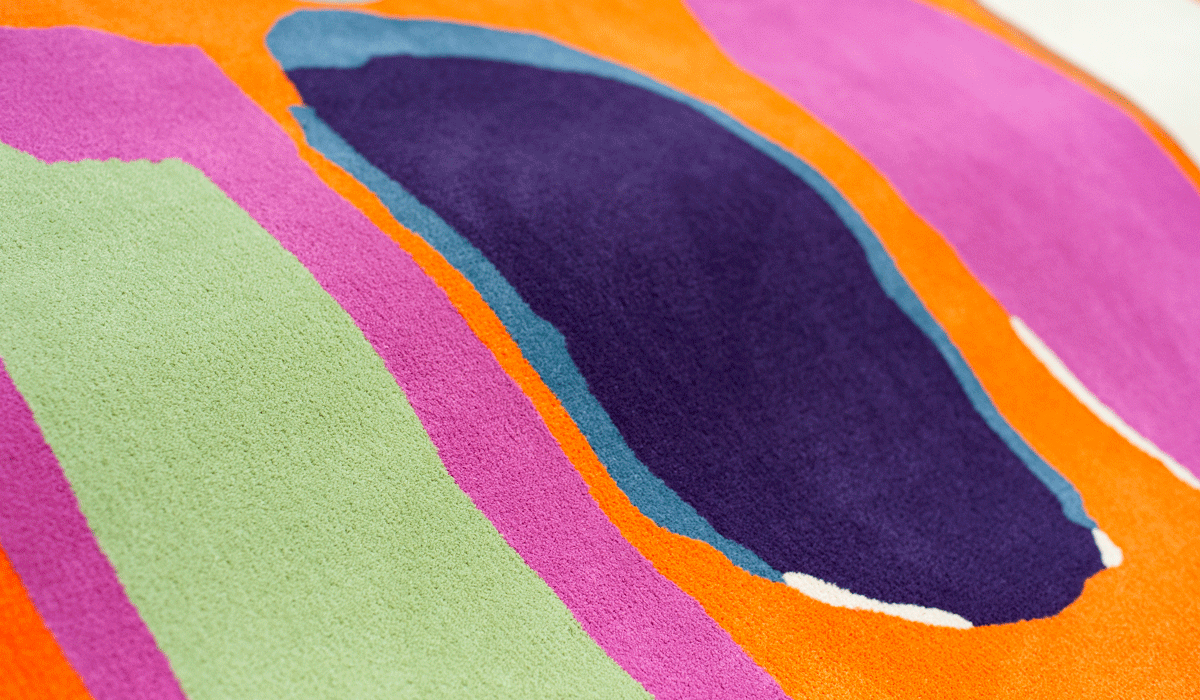 Orange pink green blue and purple custom area rug in Opulence